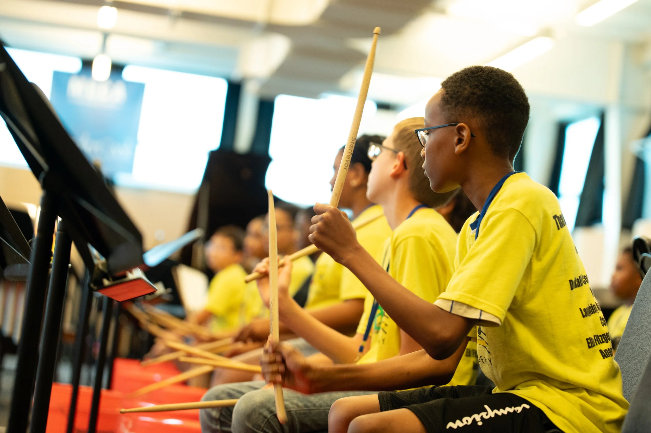 Jazz Academy students with drumsticks in a CJP classroom